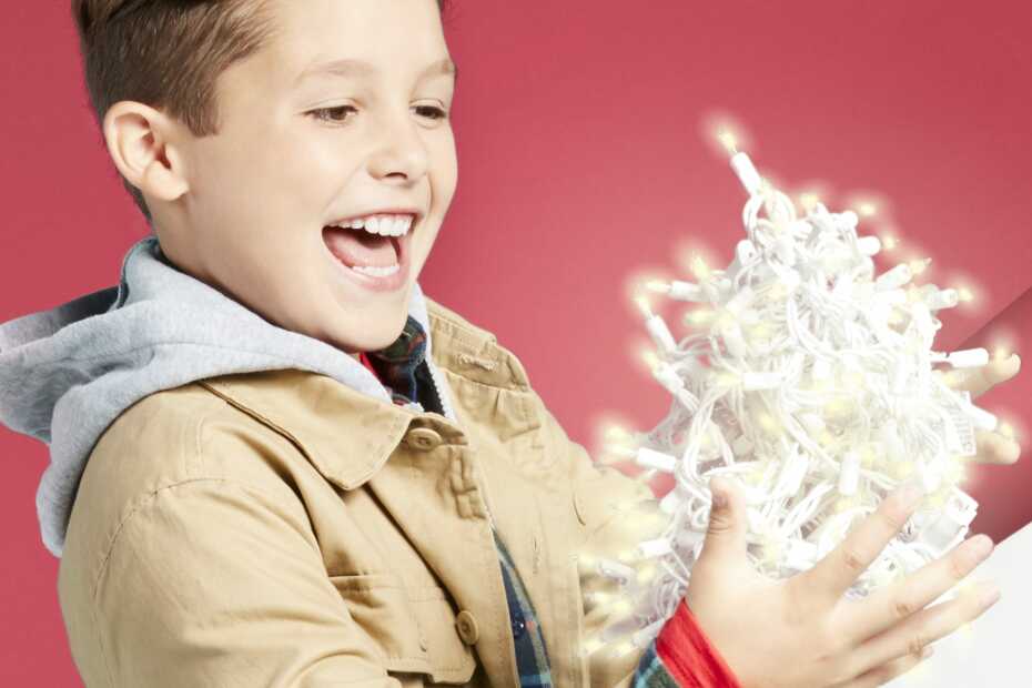 Boy looking at lit Christmas lights